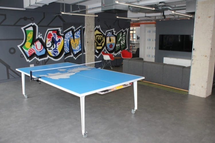 An ergonomic office space setup with an game and activity area