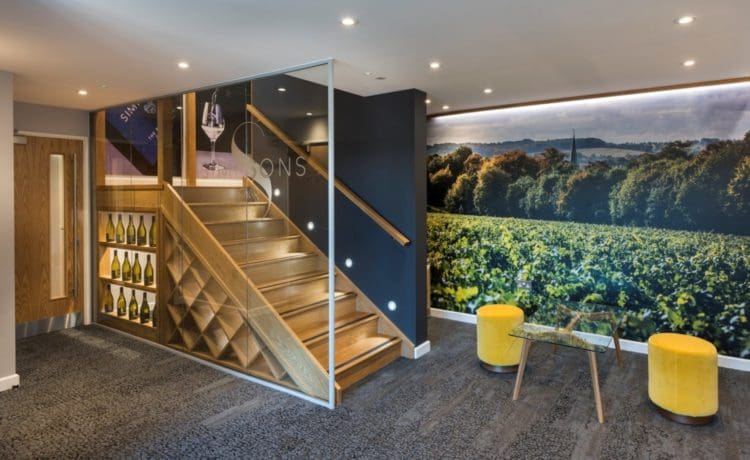 Office waiting area with a vineyard wall graphic