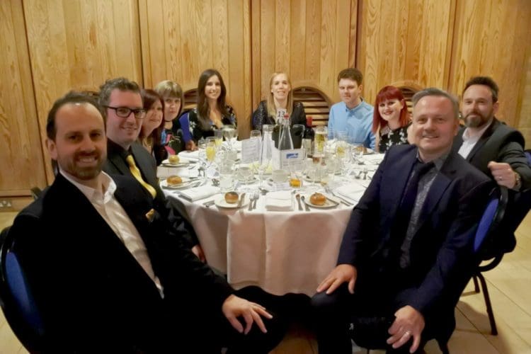 Employees from office fit out company Rap Interiors sitting at an awards ceremony dinner