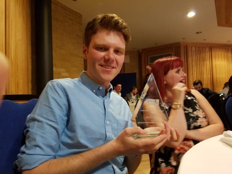 Fit out company marketing manager holding a construction project of the year award