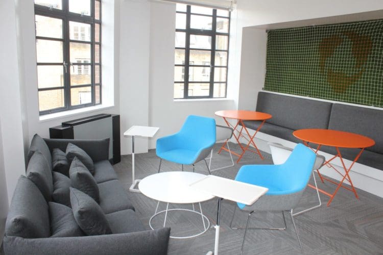 breakout area with grass walls and soft seating created by office designers