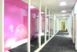a glass fronted office meeting rooms with champagne themed manifestation installed for the Crowe UK interior fit out