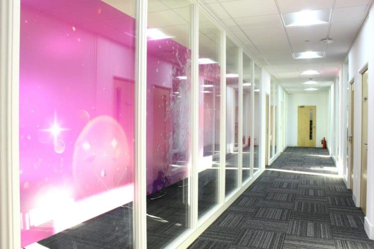 a glass fronted office meeting rooms with champagne themed manifestation installed for the Crowe UK interior fit out