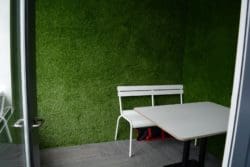 an office meeting room with artificial grass walls implemented for the hudl interior fit out