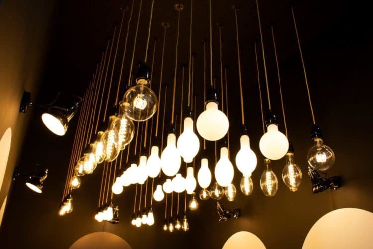 a collection of industrial hanging filament lights on show at the london olympia