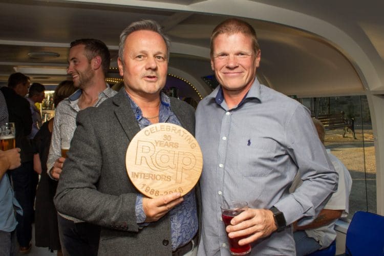 rap interiors director rick anderson being presented with a thirty years in business plaque