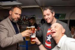three members of office fit out company rap interiors toasting for thirty years of trading
