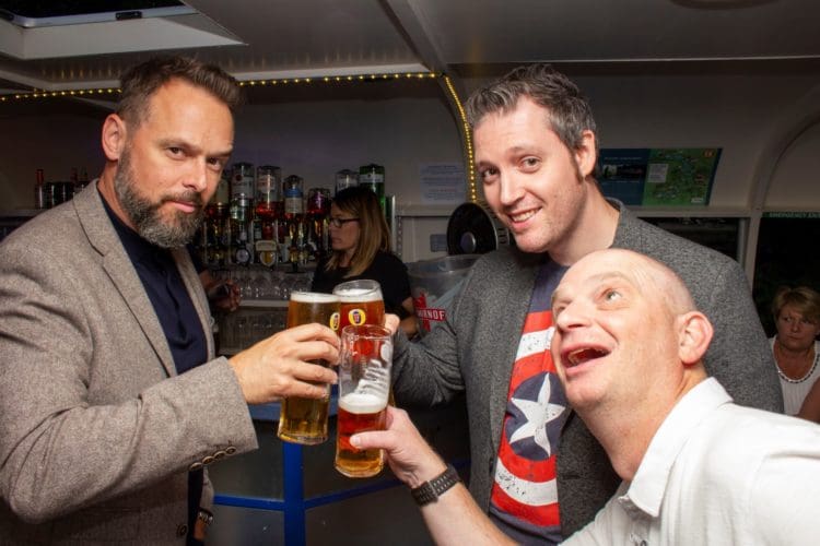 three members of office fit out company rap interiors toasting for thirty years of trading