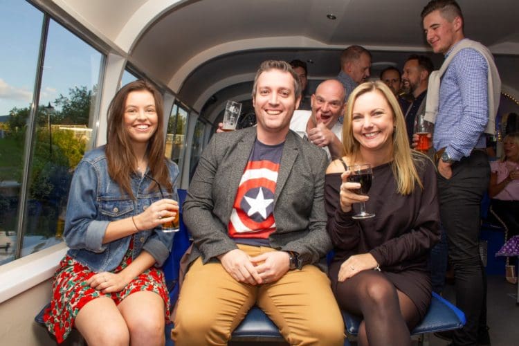 three office interior designers from london posing for a photograph at a boat party