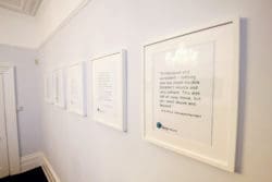 a feature wall with framed testimonials at the martin tolhurst office
