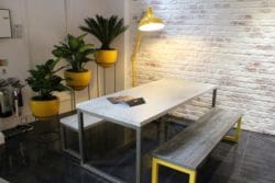 industrial office interior design with white bricks and a standing dome light