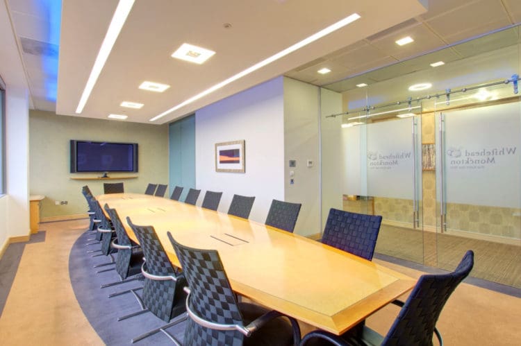 one of our commercial office design ideas to improve collaboration: a boardroom table with integrated power