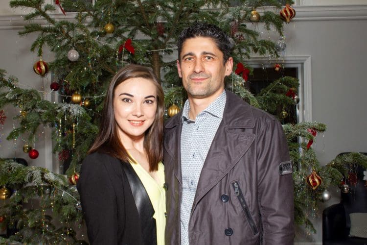 A couple posing in front of a Christmas tree at The Yarrow Hotel in Broadstairs