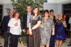 A group of guests mingling at The Yarrow Hotel for a Christmas party