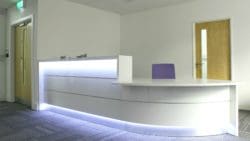 one of our commercial office interior design ideas: a reception desk with an LED motion sensor