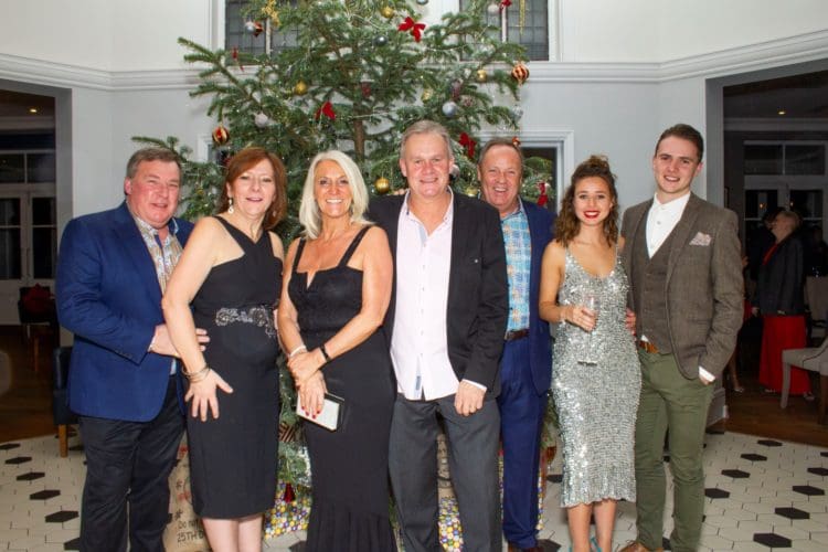 Guests enjoying themselves at an office Christmas party