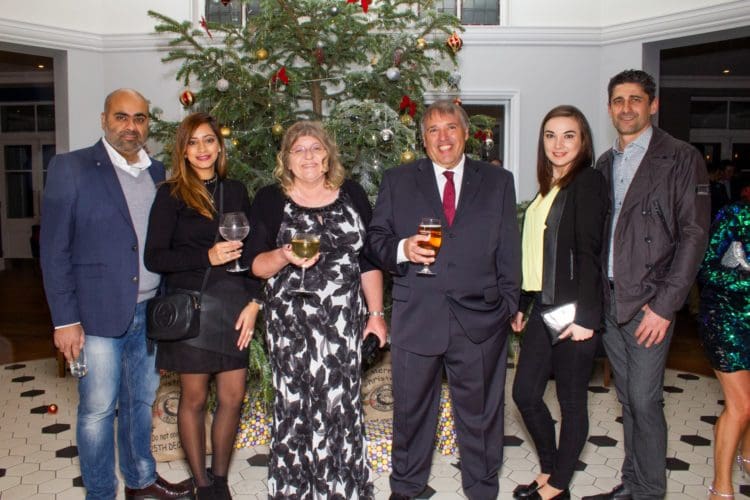 Guests posing for a photograph at an office Christmas party at The Yarrow hotel