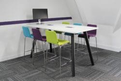 modern office interior design with colourful stools and a white meeting table