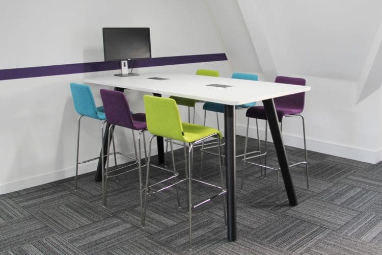 modern office interior design with colourful stools and a white meeting table