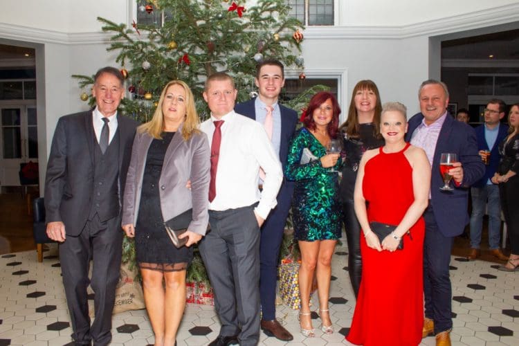 Rap Interiors directors and staff posing for a photograph at a Christmas party