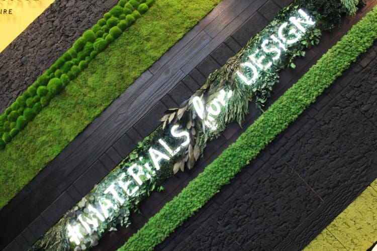 a living wall with charred material and foliage