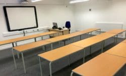 Classroom Interiors with an Electric Whiteboard and Desks