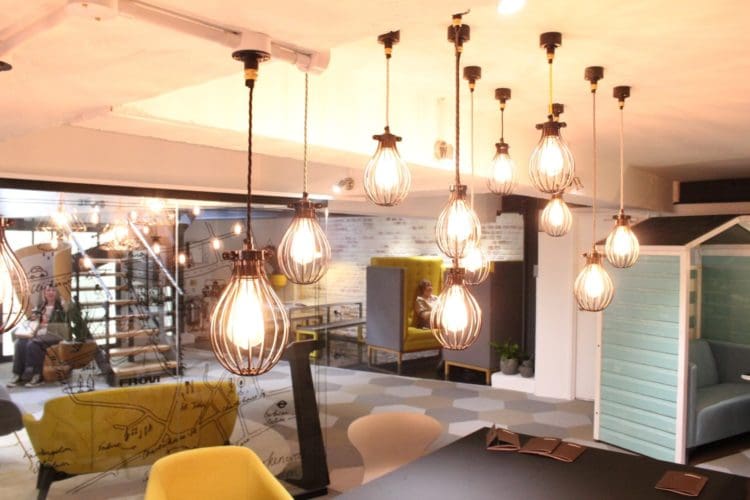 LED pendant lights with a curved shell displayed at a london interior design show