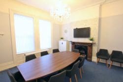Office Boardroom with a Meeting Table and Ornamental Fireplace