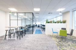 a commercial office design with a crittall glass meeting room and breakout area furniture