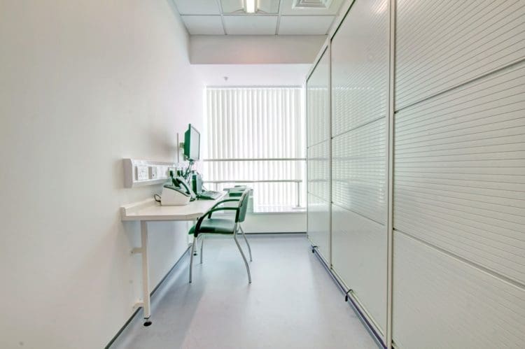 GP practice refurbishment with a consultation table and storage solutions