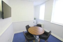 Small Meeting Room Design with Office Furniture and a Newly Laid Carpet