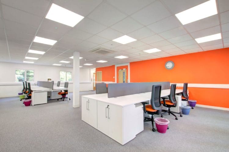 Prep World Kent: Office Interior Design with Orange Walls and Desks