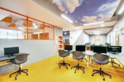a modern school space design with an imitation sky ceiling raft and desks