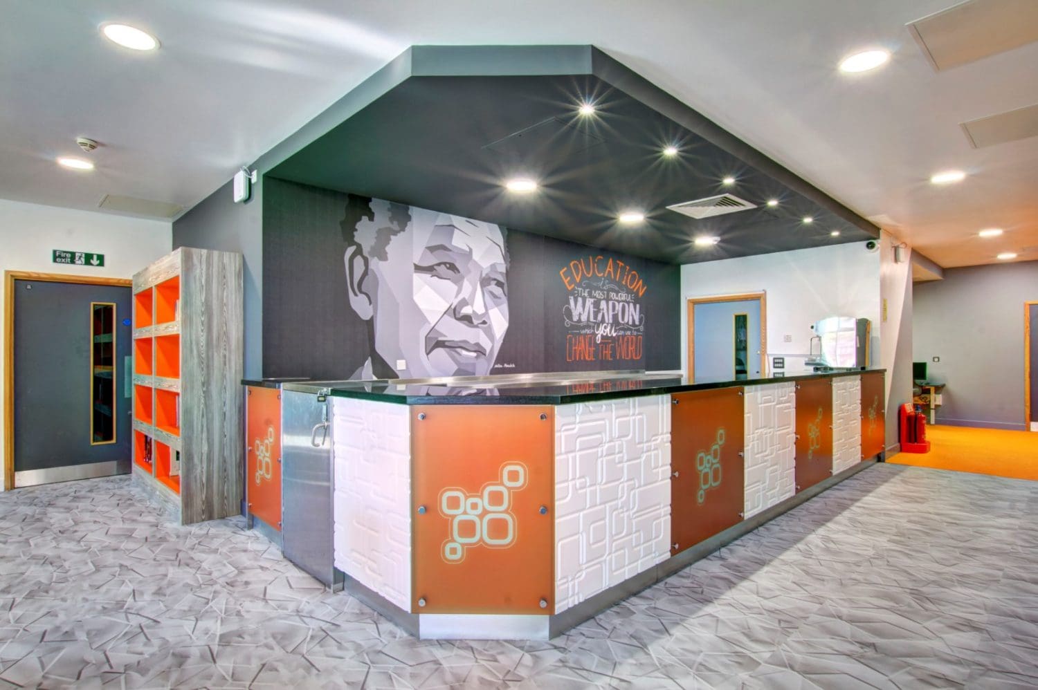 a modern serving counter design with a nelson mandela wall vinyl