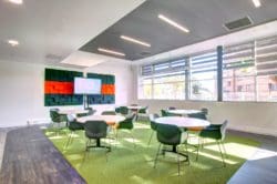 A school classroom refurbishment with a presentation screen and acoustic wall panels