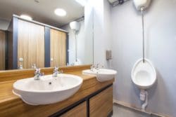 a school toilet design with wood effect cubicles by fit out company rap interiors