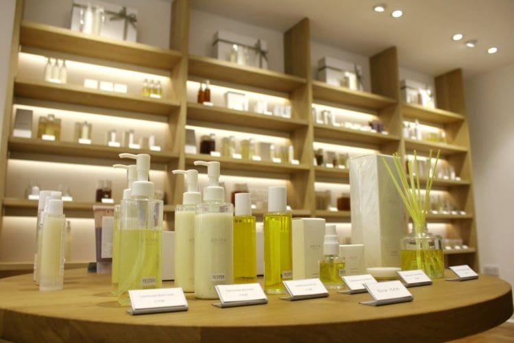 a skin care shop commercial fit out with solid wooden shelving and product table