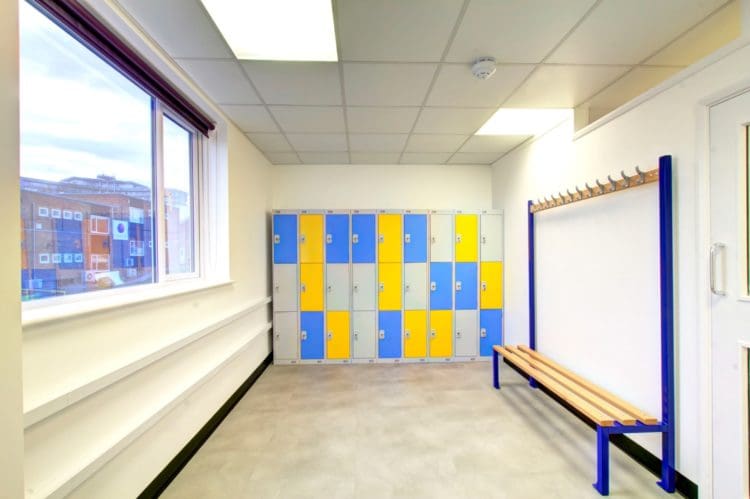 a staff changing room with a wipeable floor and lockers