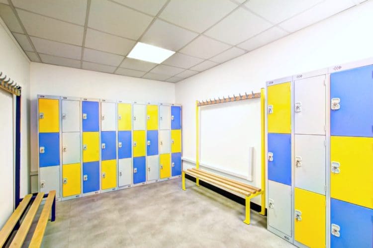 a staff changing room with lockers and benches created by refurbishment company rap interiors
