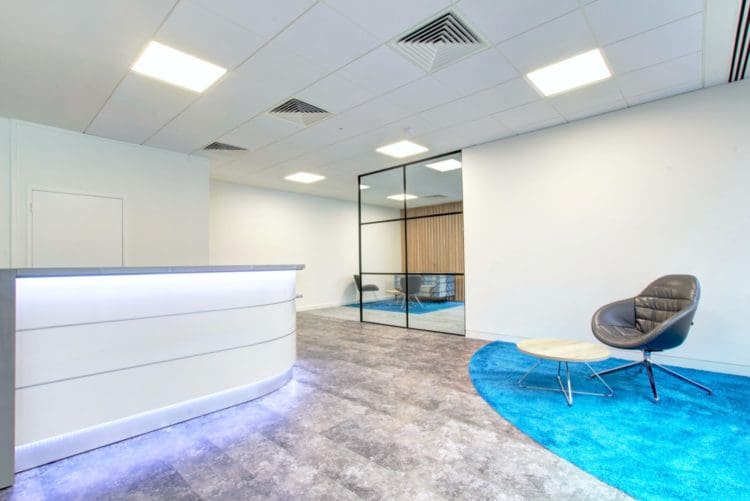 An Office Reception Area Design with an LED Sensor Light Desk and Waiting Furniture