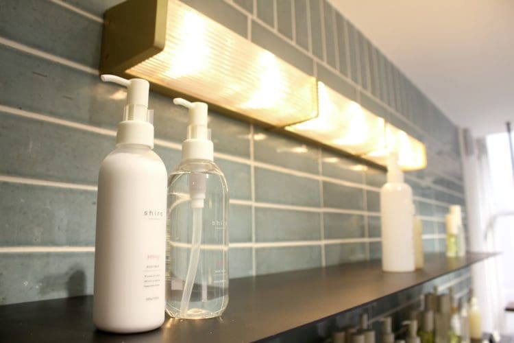 bottled shiro skin care product and flourescent light at the site of their london fit out