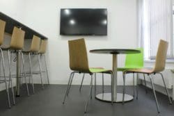 Breakout area interior design with a television and dining furniture