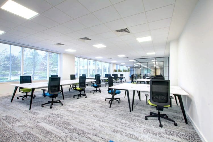 commercial interior design with shared desks and mesh back chairs