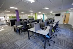 commercial office design with multicoloured pillars and distressed marble desks
