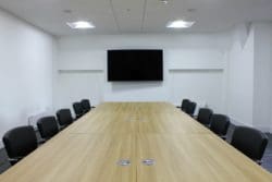 Conference Room Interior Design with a Large Shared Desk and Leather Seats