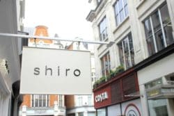 hanging shiro shop sign installed by interior designers in london