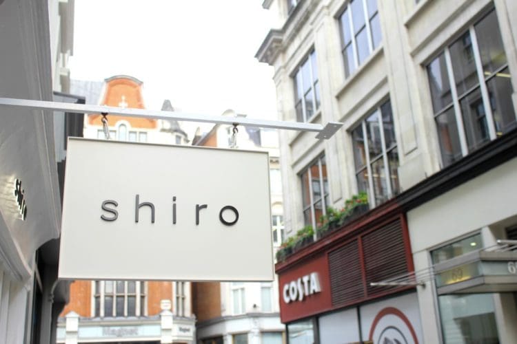hanging shiro shop sign installed by interior designers in london