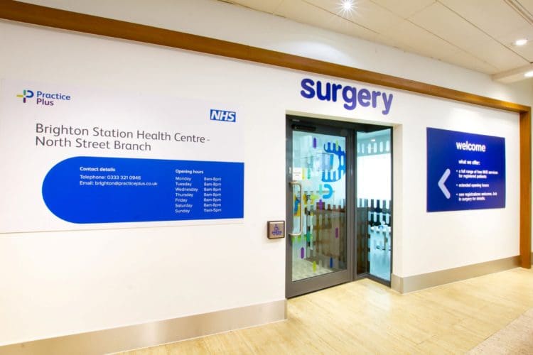 healthcare reception interior design with a push to open button and opening times sign