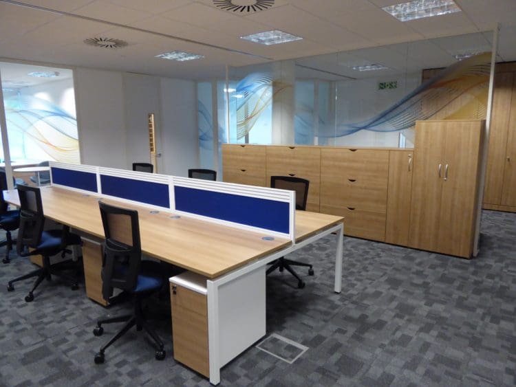 Commercial office space with desks and chairs