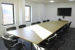 Meeting room with a conference table and TV installed for the CCW commercial fit out